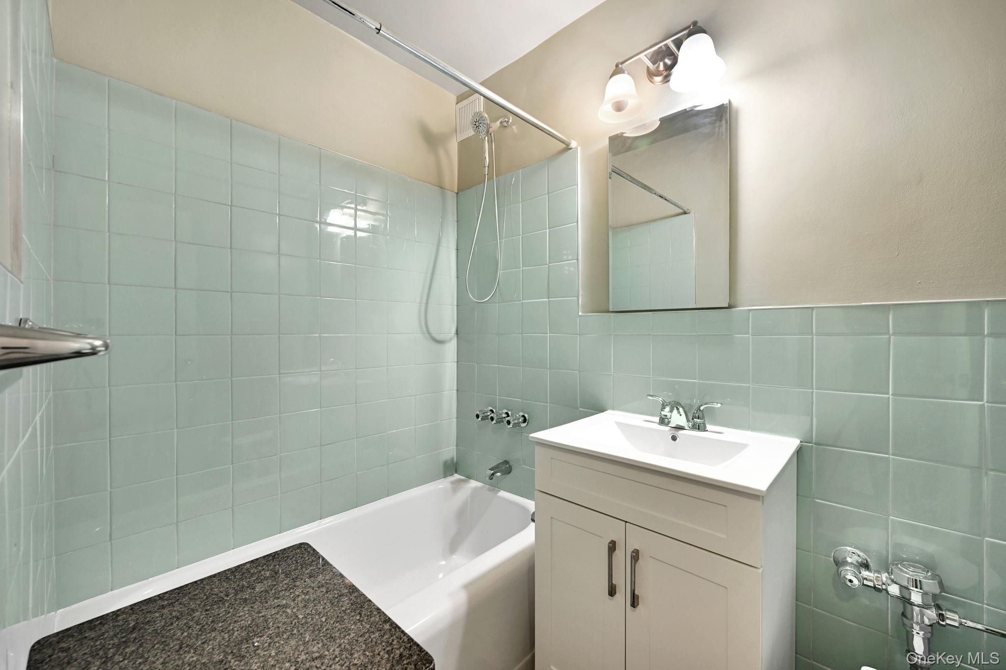 3131 Grand Concourse, Unit 3C Bronx, NY 10468 - Photo 10 of 27 a bathroom with a sink a toilet and shower