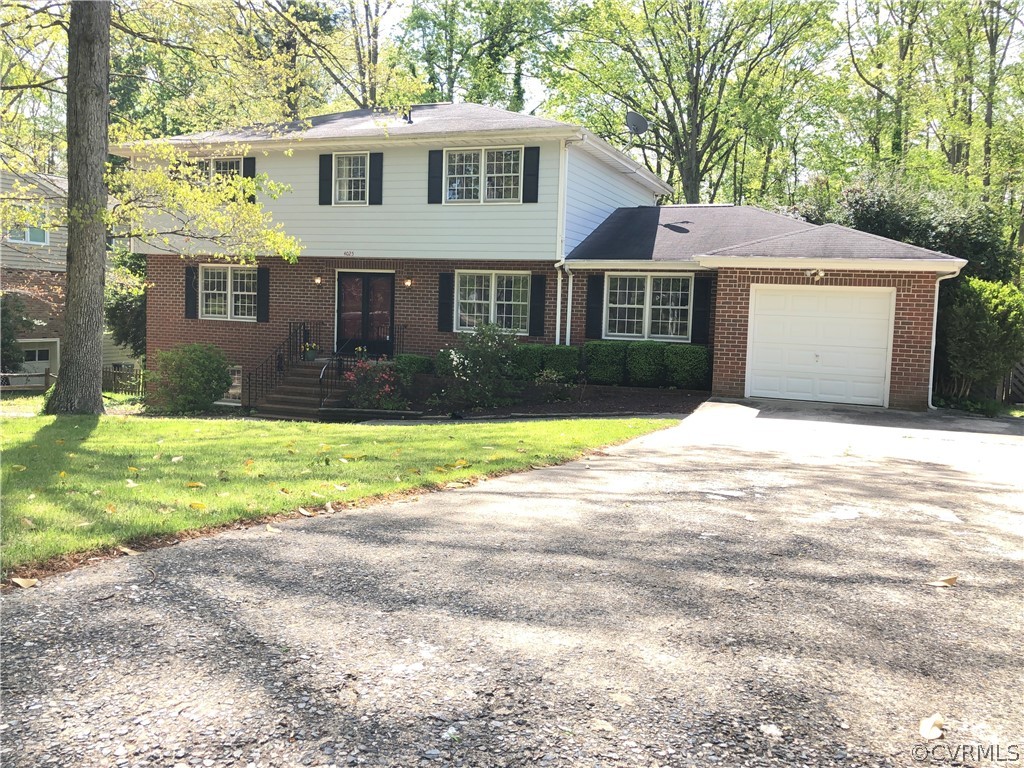 4025 Hidden Valley Road Chester, VA 23831 - Photo 1 of 23 a front view of a house with a yard and trees