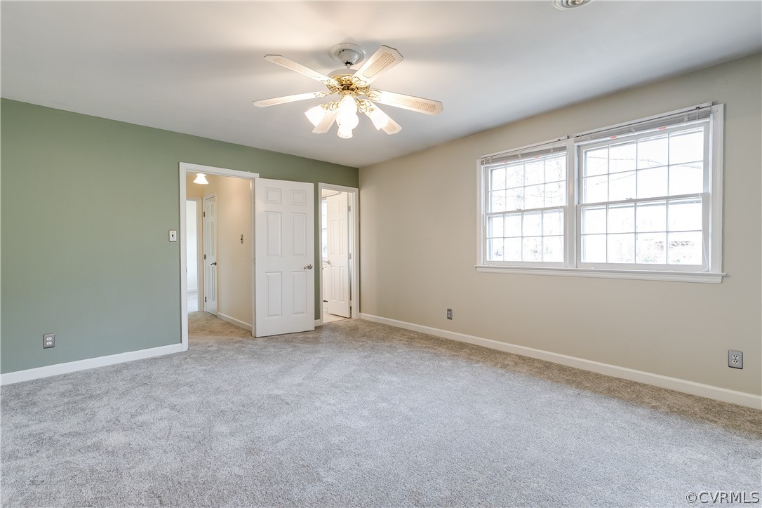 4025 Hidden Valley Road Chester, VA 23831 - Photo 16 of 23 an empty room with chandelier fan and windows