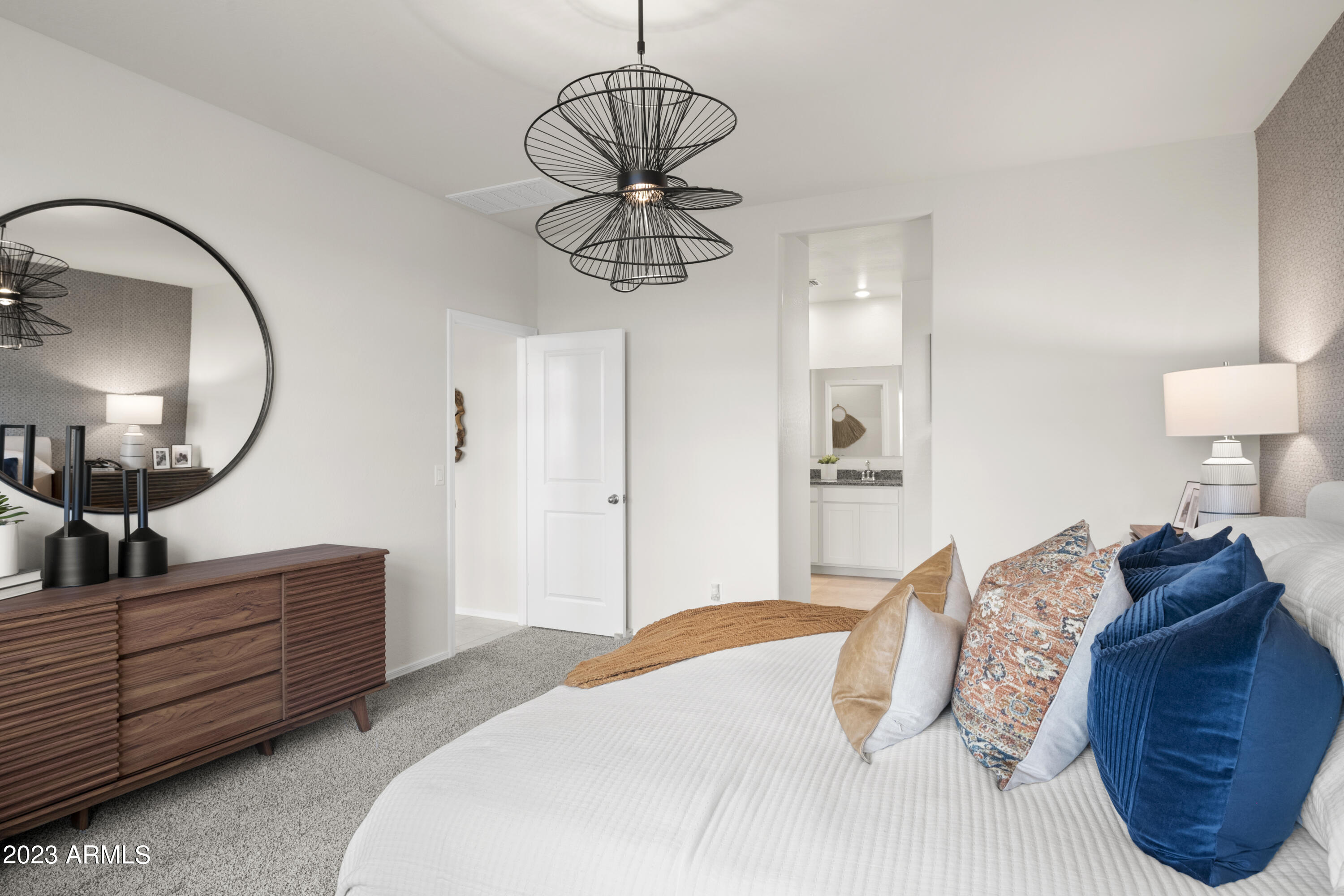 2374 West Solstice Avenue Apache Junction, AZ 85120 - Photo 16 of 59 a bedroom with a large bed and a chandelier