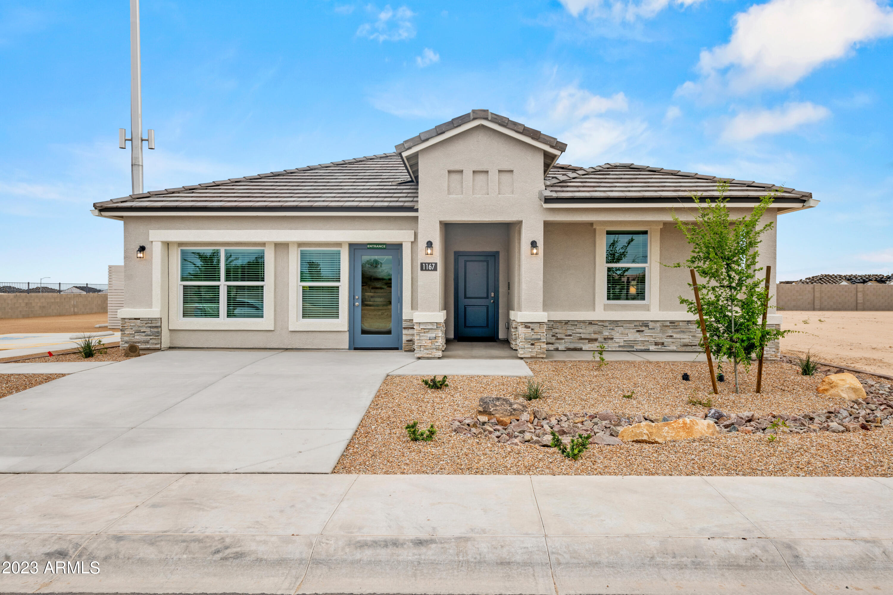 2374 West Solstice Avenue Apache Junction, AZ 85120 - Photo 2 of 59 a front view of a house with a yard and garage