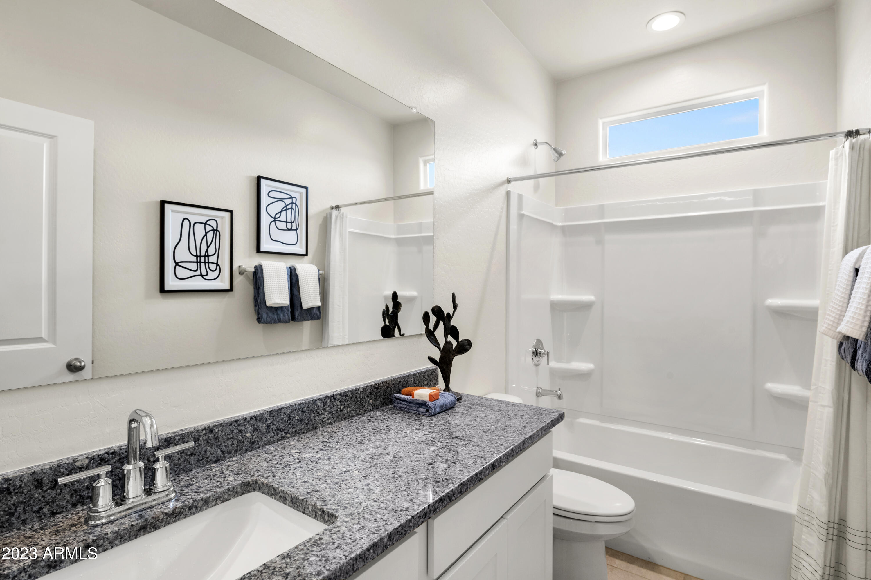 2374 West Solstice Avenue Apache Junction, AZ 85120 - Photo 31 of 59 a bathroom with a granite countertop sink a toilet and bathtub