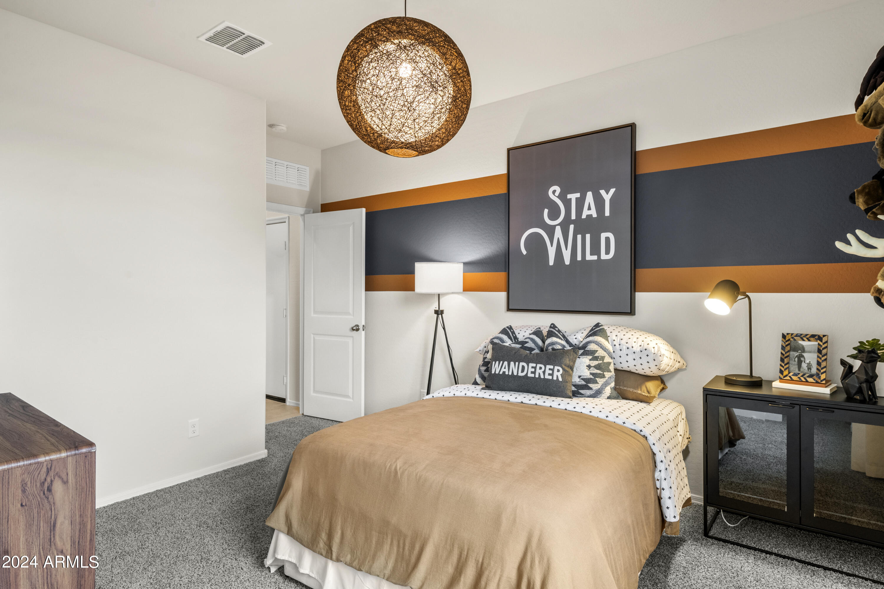 2374 West Solstice Avenue Apache Junction, AZ 85120 - Photo 58 of 59 a bedroom with a bed and a lamp on dresser