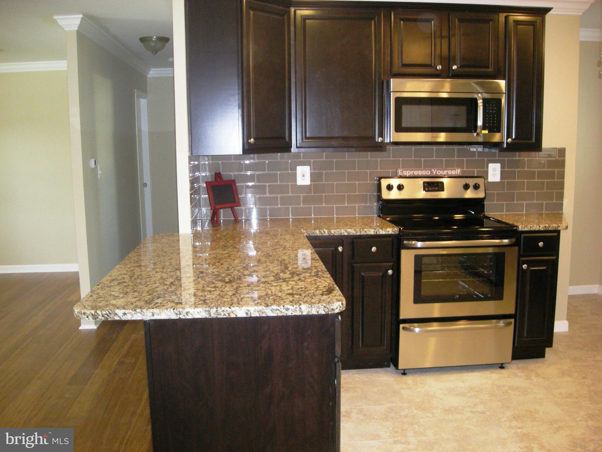 2100 Bayberry Road Edgewood, MD 21040 - Photo 7 of 30 a kitchen with stainless steel appliances granite countertop a stove a microwave and a sink