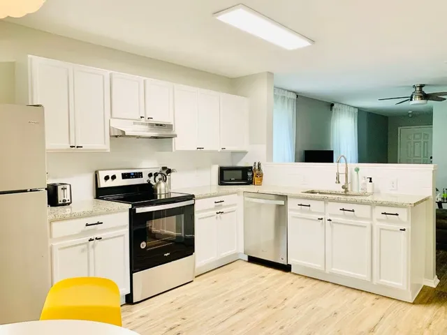 a kitchen with a stove a sink and a refrigerator