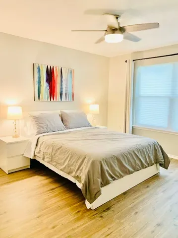 a bedroom with a bed and a painting on the wall