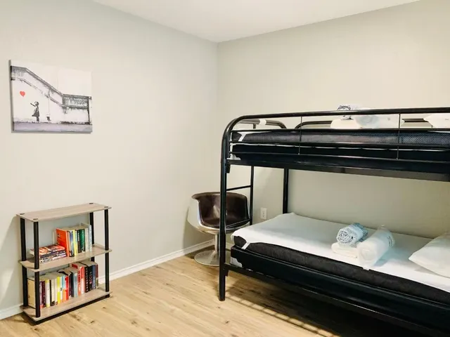 a view of bedroom with furniture and wooden floor