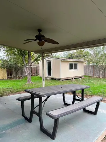 a view of a patio with a table chairs and a backyard