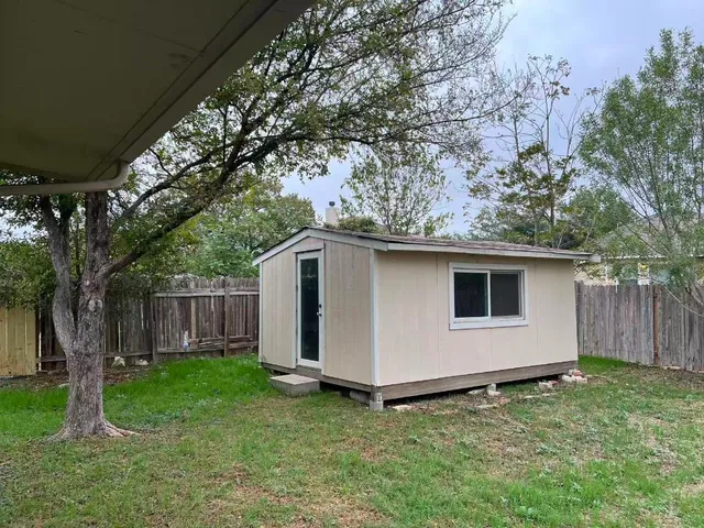 a house with a tree in the grass