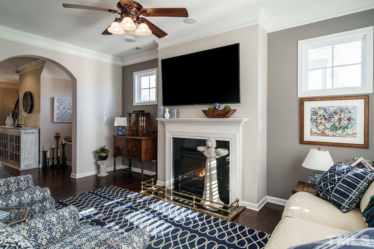 1344 Rodessa Run Raleigh, NC 27607 - Photo 11 of 38 a living room with furniture a flat screen tv and a fireplace