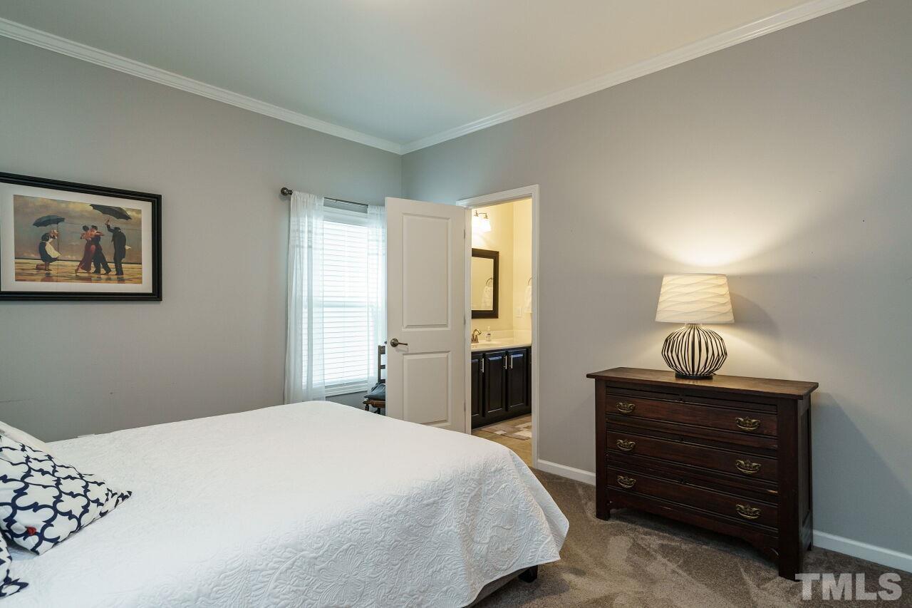 1344 Rodessa Run Raleigh, NC 27607 - Photo 24 of 38 a bedroom with a bed and a lamp on dresser
