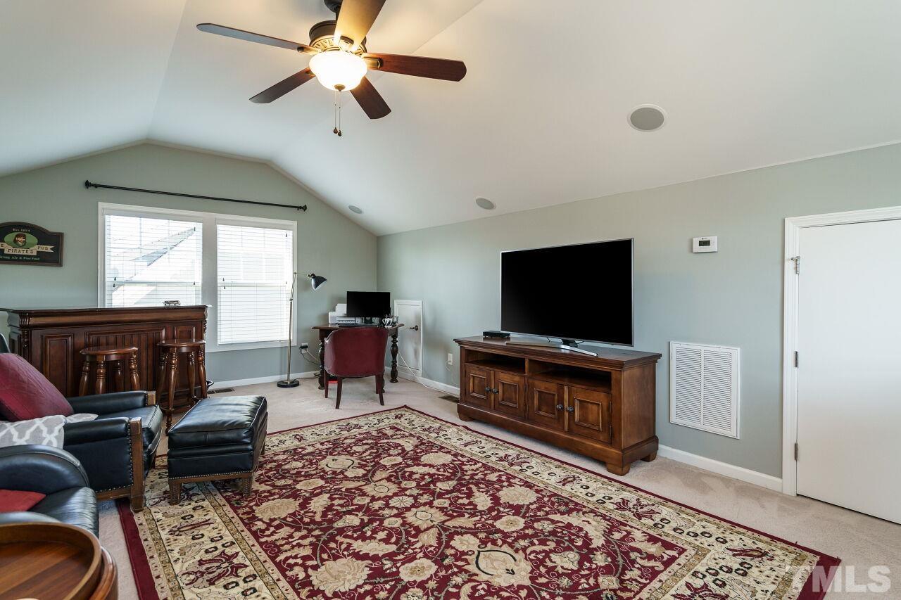 1344 Rodessa Run Raleigh, NC 27607 - Photo 32 of 38 a living room with furniture and a flat screen tv