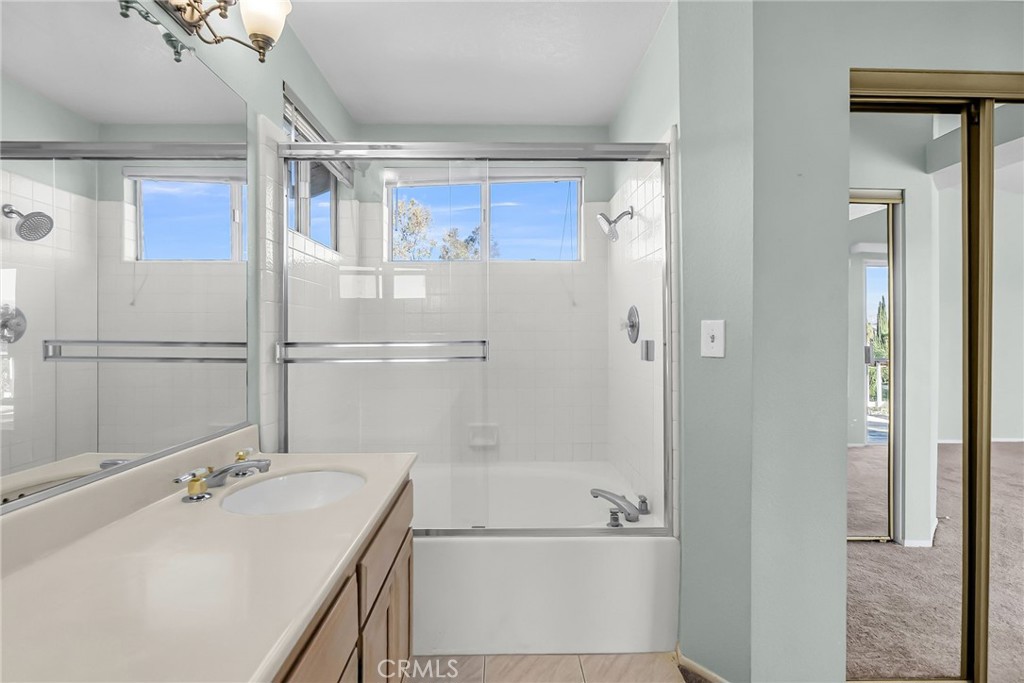 1011 Cannon Road Riverside, CA 92506 - Photo 21 of 46 a bathroom with a tub sink and mirror