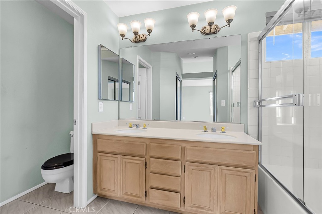 1011 Cannon Road Riverside, CA 92506 - Photo 22 of 46 a bathroom with a double vanity sink mirror and toilet