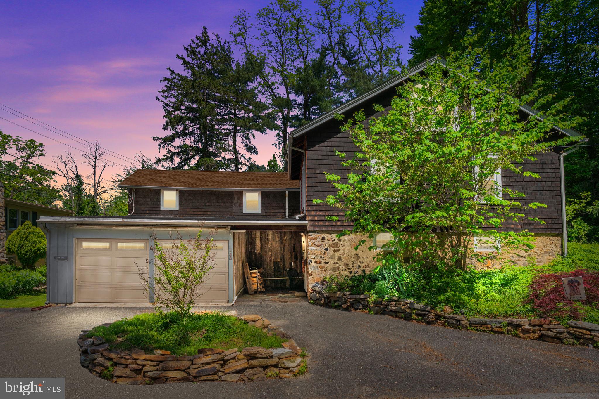 a front view of a house with a yard and potted plants