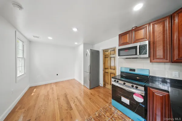 a kitchen with stainless steel appliances granite countertop a stove and a refrigerator