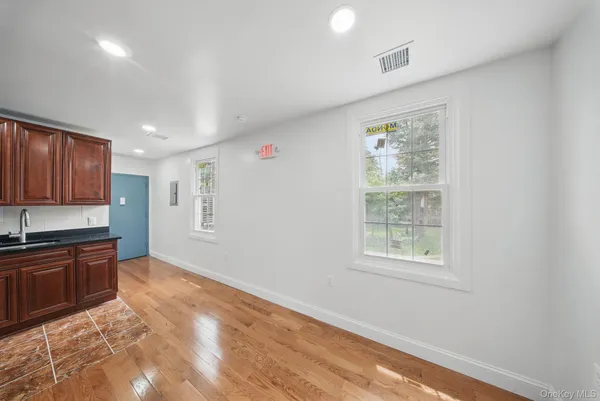 a view of a kitchen with granite countertop cabinets and wooden floor