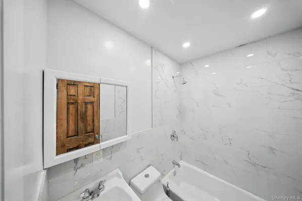 a bathroom with a bathtub and a shower