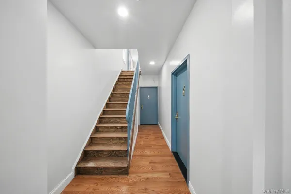 a view of a hallway with wooden floor and entryway