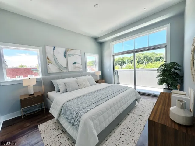 a bedroom with a bed and a large window