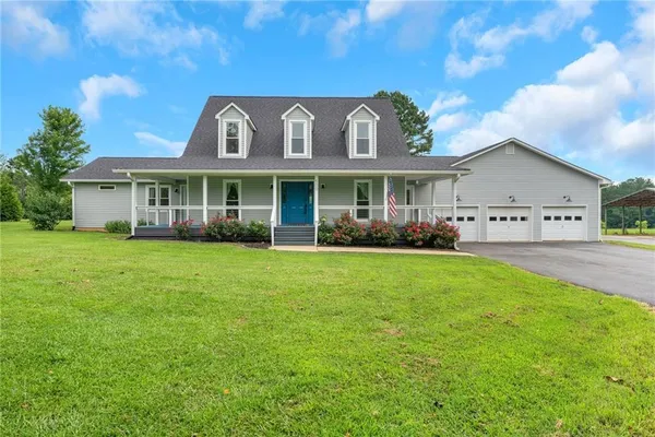 a front view of house with yard and green space