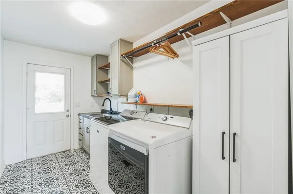 a spacious bathroom with a granite countertop double vanity and mirror