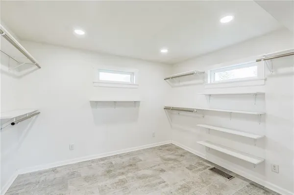 a view of a big room with wooden floor and closet in a room