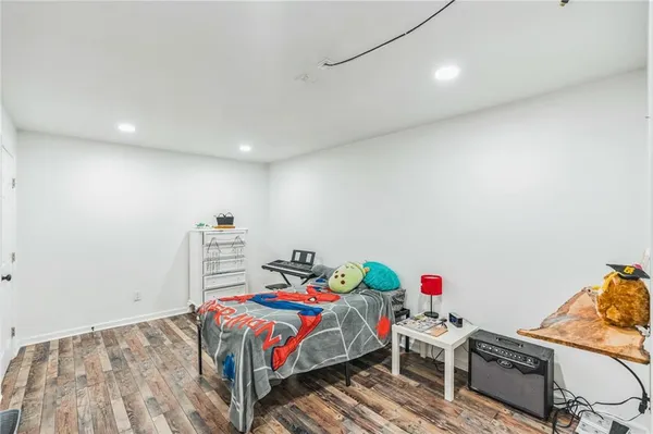an empty room with wooden floor a ceiling fan and windows