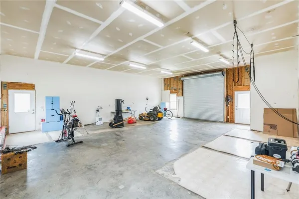 a view of a hallway with wooden floor and a window