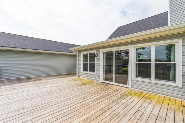 a kitchen with stainless steel appliances granite countertop a refrigerator a sink dishwasher a stove and white countertops with wooden floor