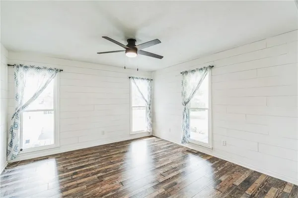 a large kitchen with stainless steel appliances kitchen island granite countertop a large island in the center