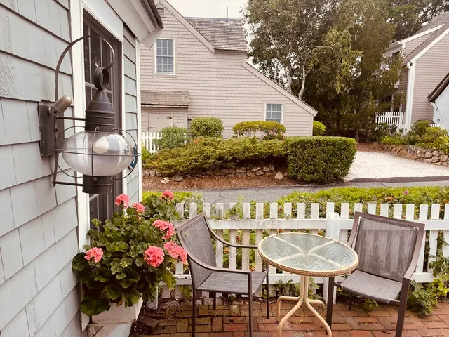 a view of a patio with a table and chairs