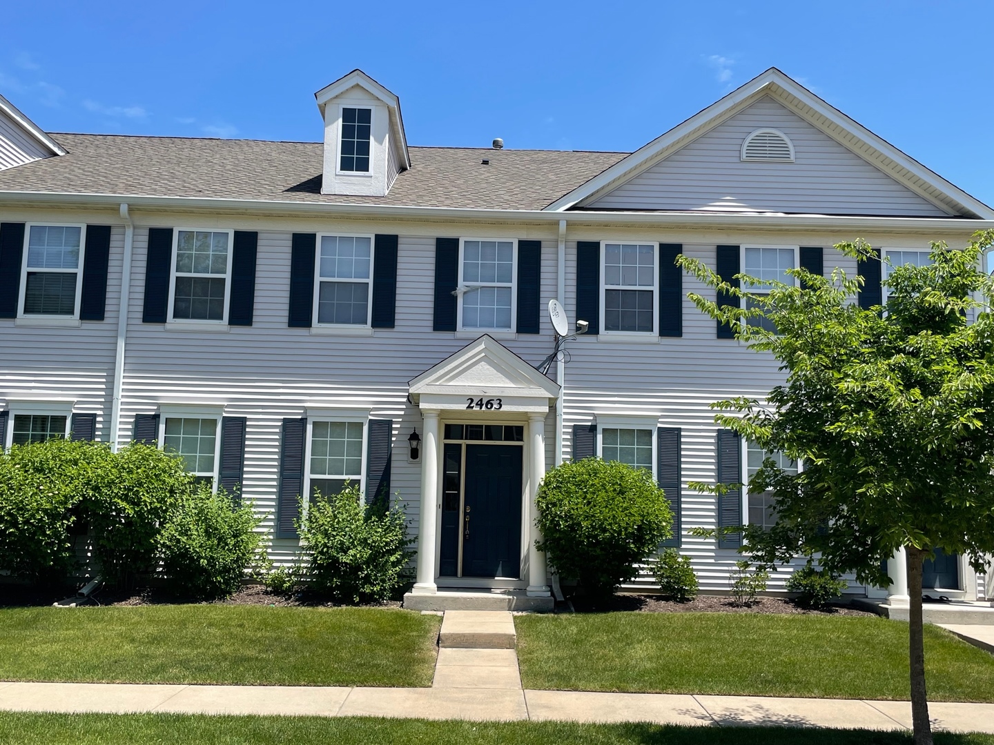 a front view of a house with a yard