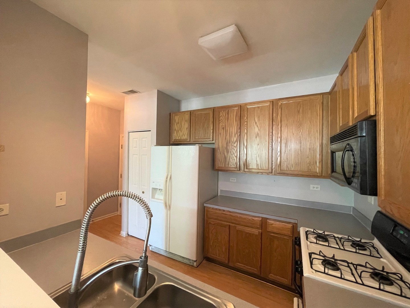 2463 Georgetown Circle Aurora, IL 60503 - Photo 5 of 21 a kitchen with stainless steel appliances granite countertop a refrigerator and a stove top oven