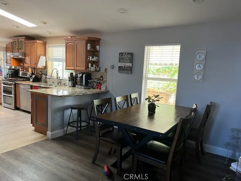 1616 South Euclid Street, Unit 54 Anaheim, CA 92802 - Photo 3 of 11 a view of a dining room with furniture and wooden floor