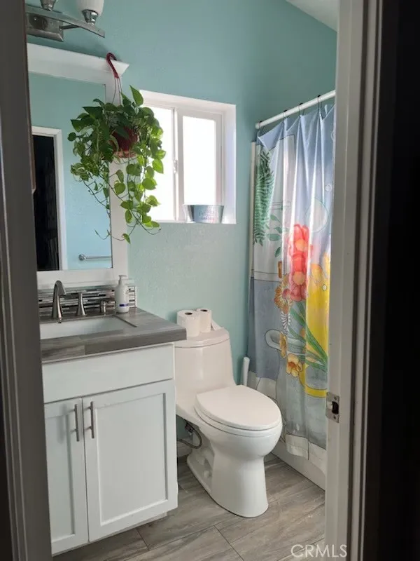 1616 South Euclid Street, Unit 54 Anaheim, CA 92802 - Photo 6 of 11 a bathroom with a toilet sink and mirror