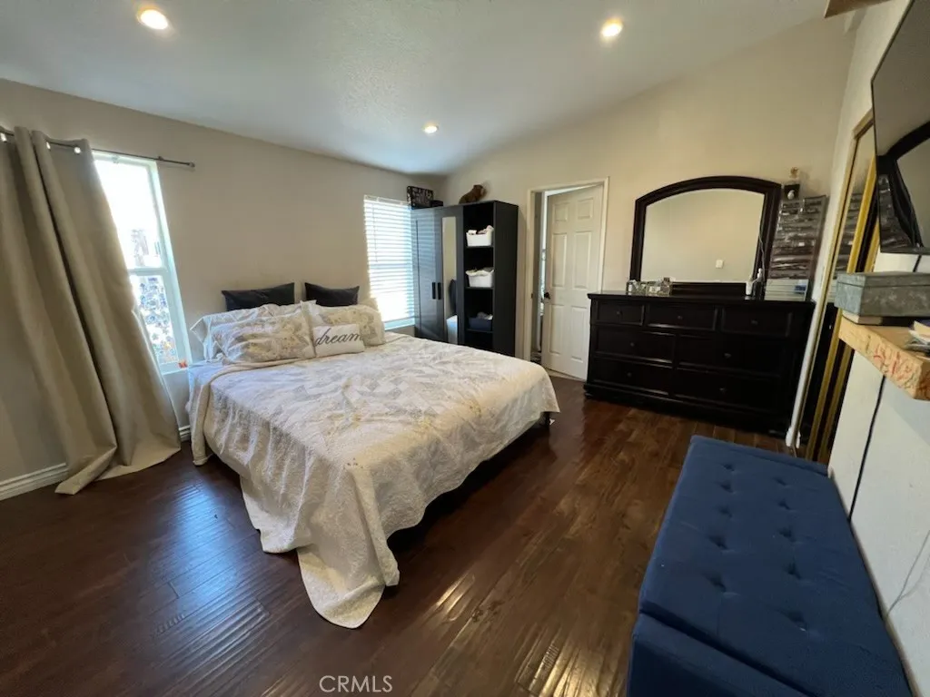 1616 South Euclid Street, Unit 54 Anaheim, CA 92802 - Photo 8 of 11 a bedroom with a bed and a large mirror on dresser