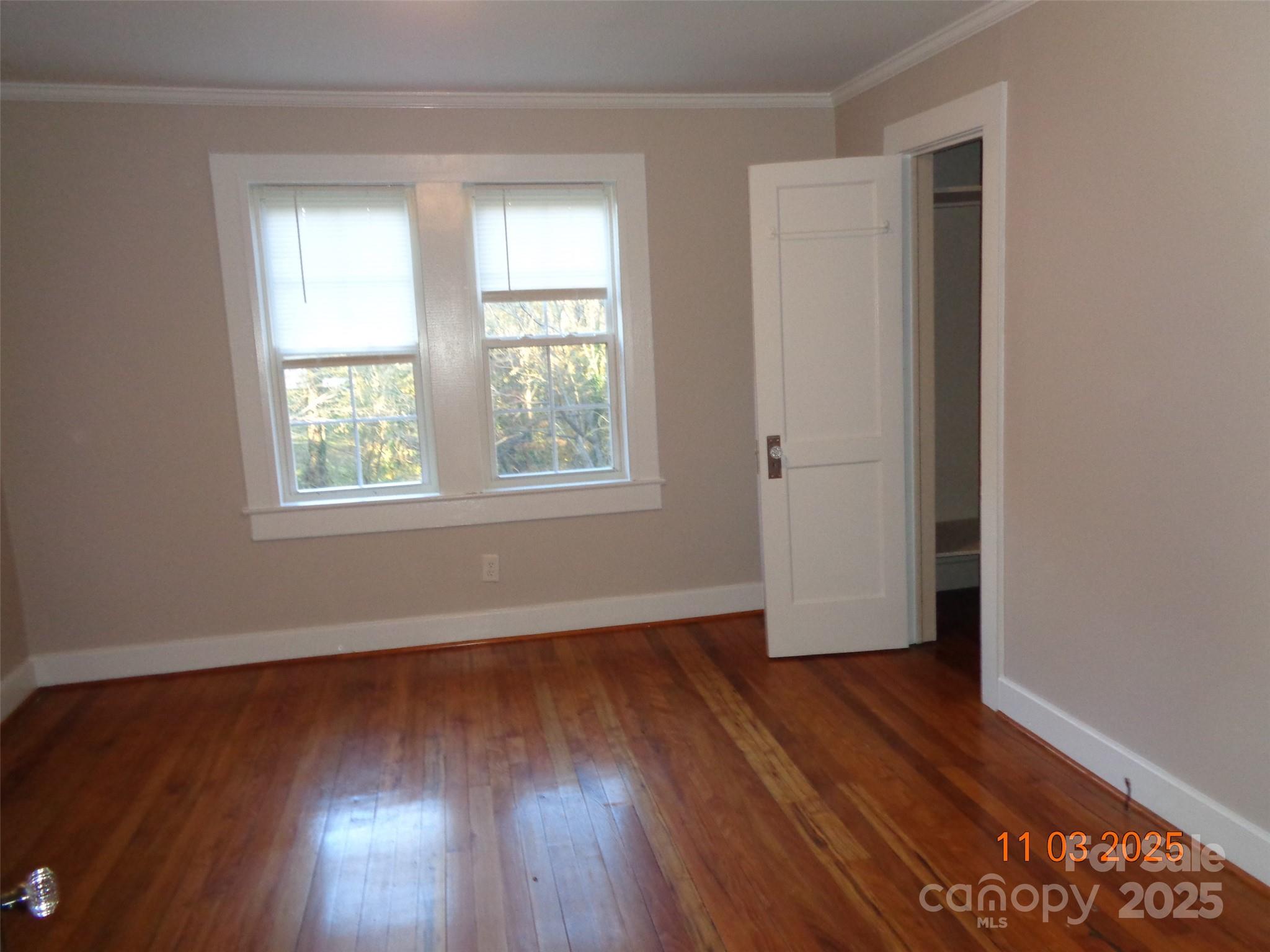 1412 Walt Arney Road Lenoir, NC 28645 - Photo 11 of 20 an empty room with wooden floor and windows