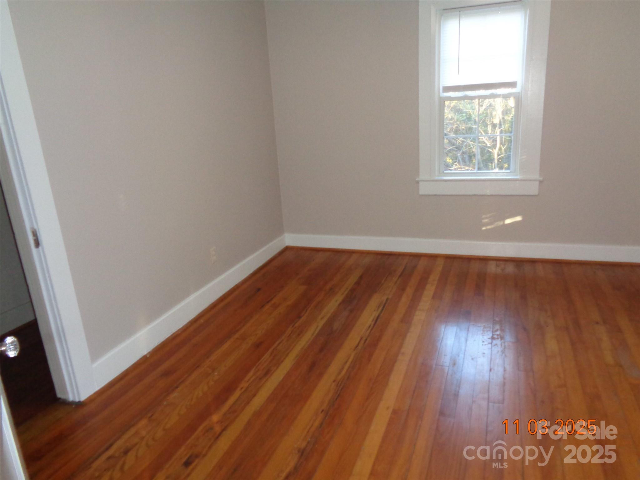 1412 Walt Arney Road Lenoir, NC 28645 - Photo 14 of 20 an empty room with wooden floor and windows