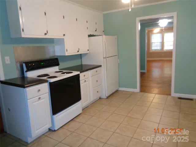 a kitchen with cabinets and white appliances