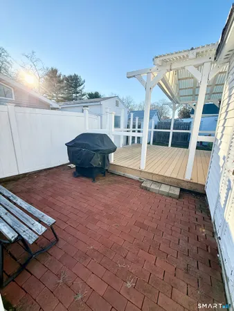 a view of a terrace with wooden floor and seating space