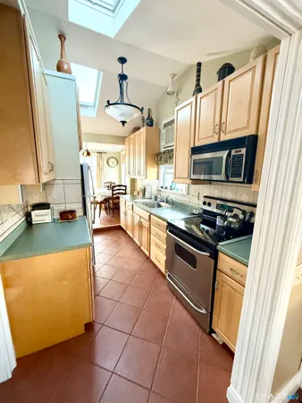 a kitchen with stainless steel appliances granite countertop a stove and a sink
