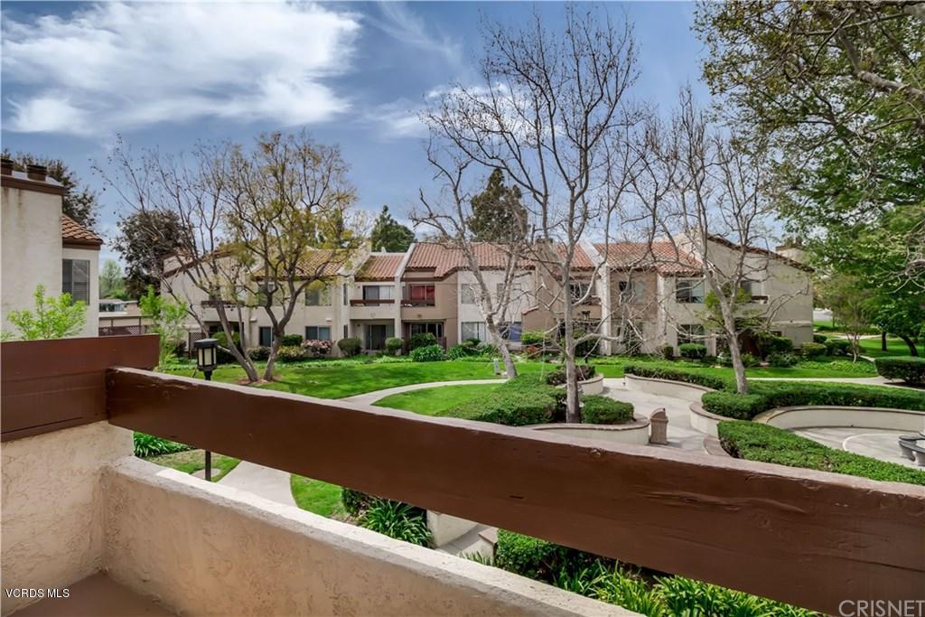1718 Sinaloa Road, Unit 216 Simi Valley, CA 93065 - Photo 22 of 24 a view of a house with a yard and large trees