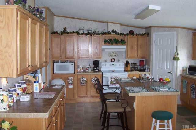 2168 Elevation Road Four Oaks, NC 27524 - Photo 2 of 9 Huge kitchen with breakfast bar and stained cabinets Other