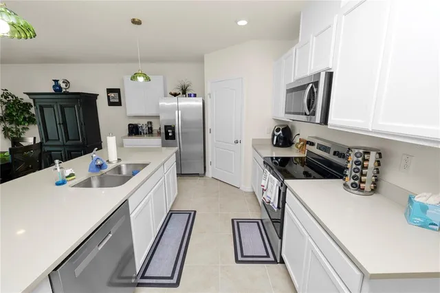 a kitchen that has a sink and a stove in it