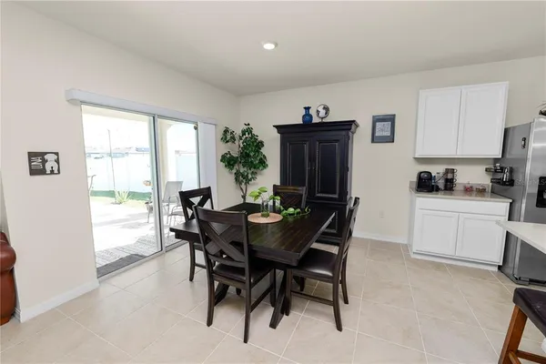 a view of a dining room with furniture and a window