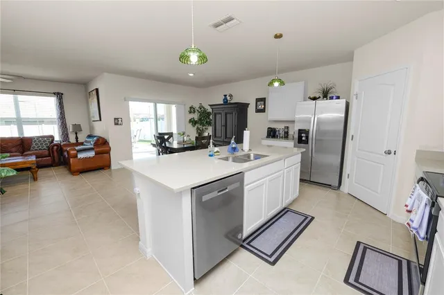 a kitchen that has a lot of cabinets and refrigerator