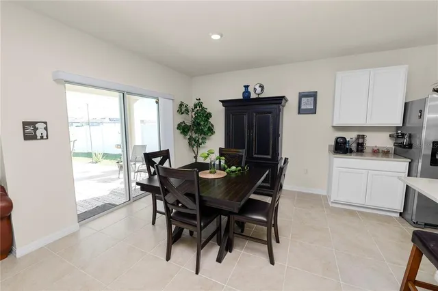 a view of a dining room with furniture and a window