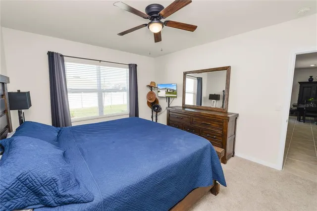 a bedroom with a bed and a television on desk