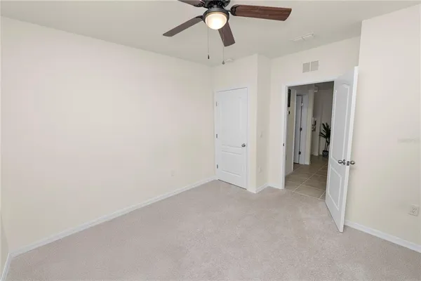 a bedroom with a bed a couch and a chandelier